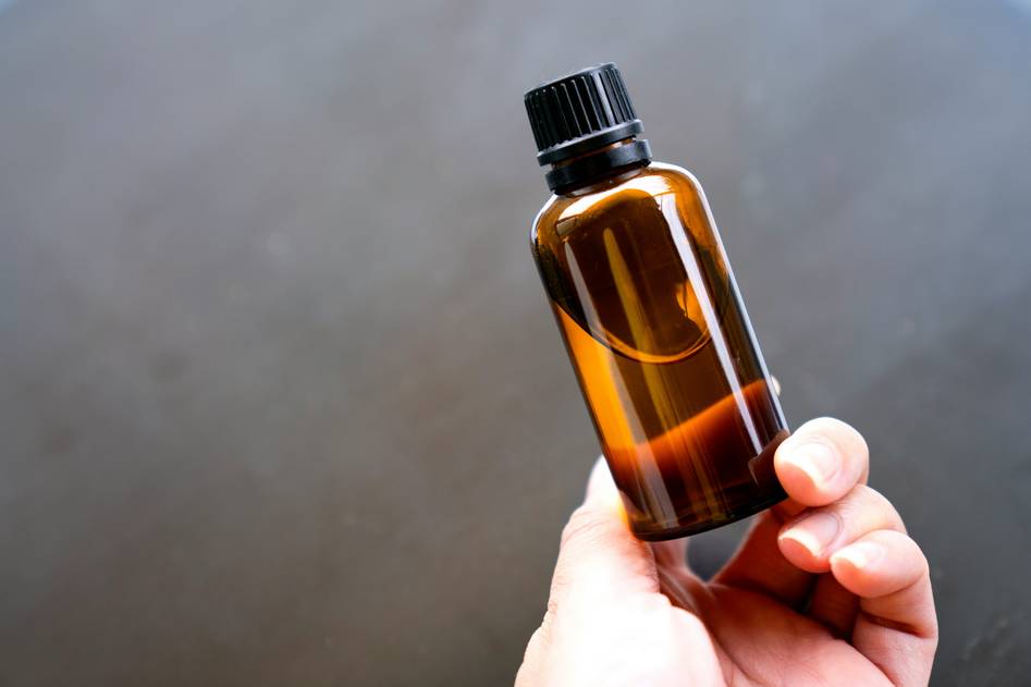 Bottles of essential oils arranged on linen cloth with soft natural lighting