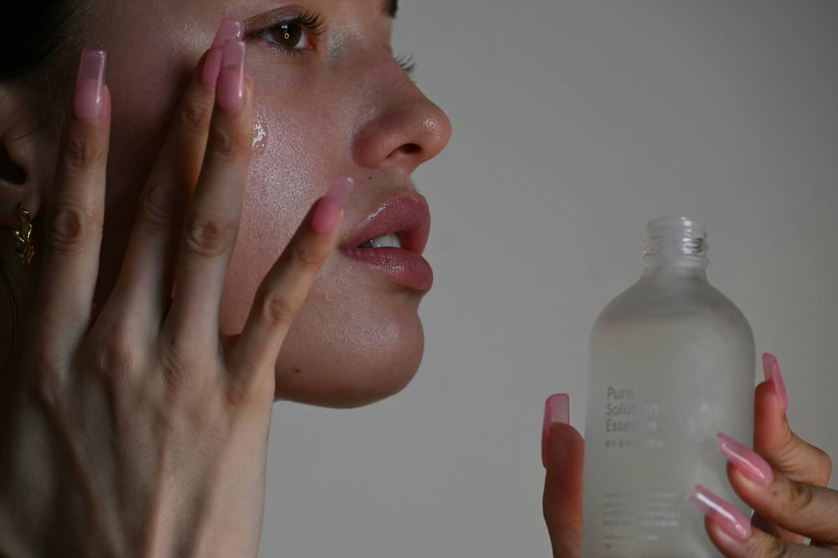 Woman enjoying a calm aromatherapy skincare ritual with oils and steam, illustrating sensations guide to aromatherapy