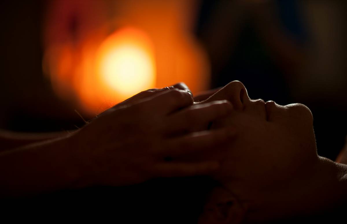 what is aromatherapy massage: hands massaging shoulders with lavender oil on skin